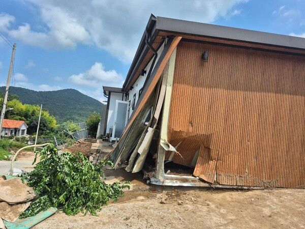 옹벽이 무너지면서 밀려든 토사로 인해 주택 한편이 힘없이 주저앉아 무너져 내린 수해 현장.