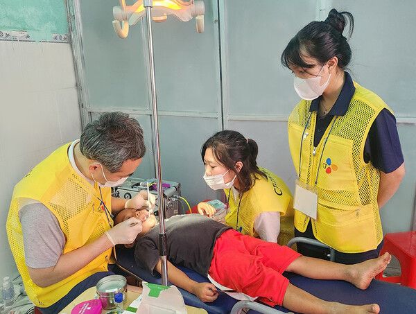 CJ그룹이 베트남 닌투언성 땀응마을을 찾아 의료봉사를 한 가운데 의료진이 베트남 어린이를 진찰하고 있다. [사진=CJ그룹](포인트경제)