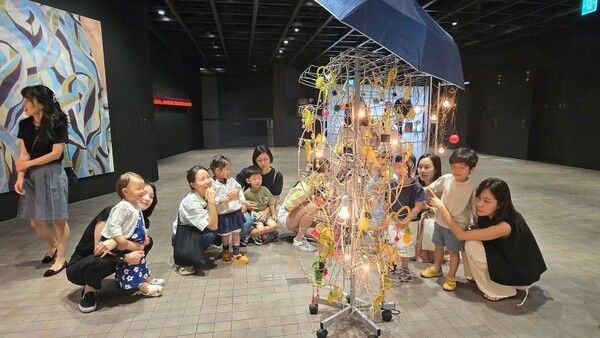 서울 용산구 누리터어린이집 유아와 부모가 함께 양혜규 '서울 근성-서울 멋쟁이' 작품을 감상하고 있다.