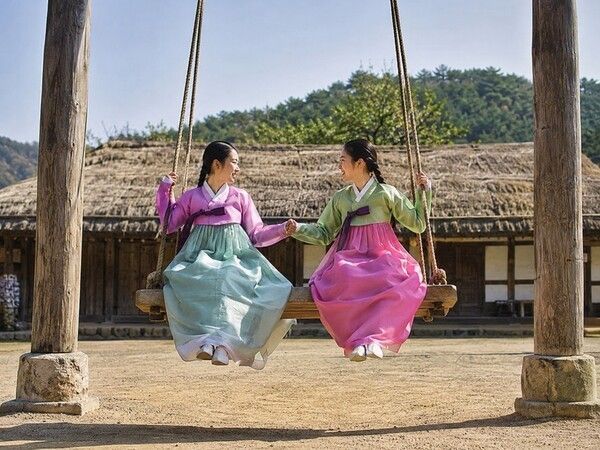 Two riders face each other on a ground-mounted double swing. Their perfectly synchronized movement provides the force needed to rise vertically. Photo courtesy of AI-generated image