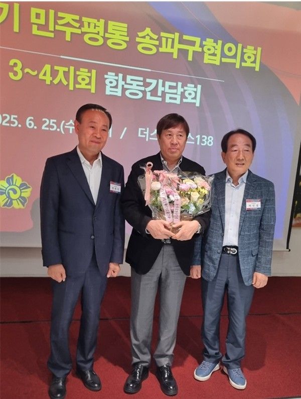 홍재성 협의회 회장에게 3ㆍ4지회 회장이 꽃다발 증정 후 함께했다.(국제뉴스=박종진 기자)