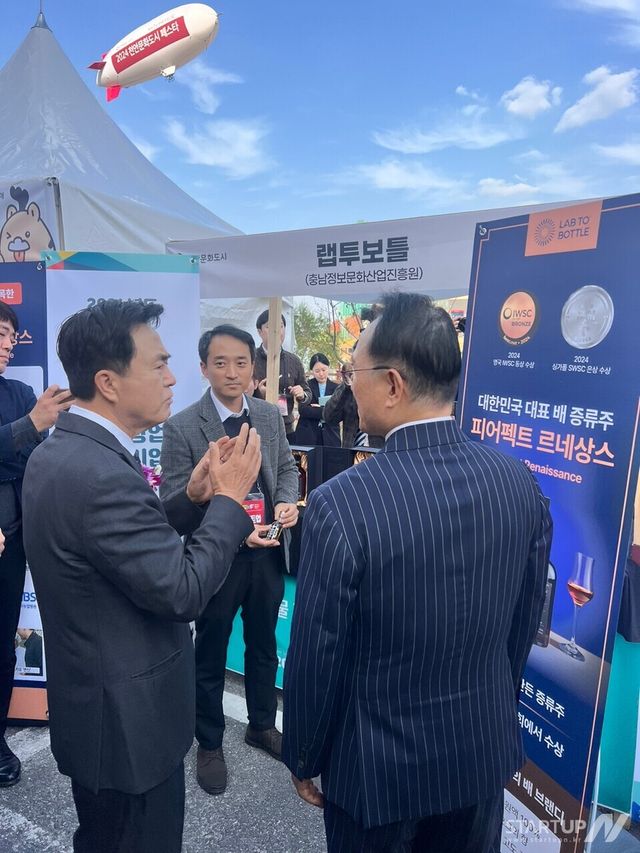 지난 13일 '2024 천안문화도시 천안의 모든 사이 뜰마켓' 행사에서 랩투보틀(대표 이동헌) 관계자가 김태흠 충청남도지사, 박상돈 천안 시장에게 제품 설명을 진행하고 있는 모습