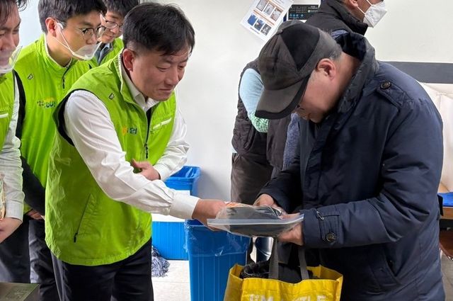 ©AP신문(AP뉴스)/이미지 제공 = 농협중앙회 ▲19일 서울 용산구 소재 무료 급식소 따스한채움터에서 이광수 농협중앙회 농업농촌지원본부장(왼쪽)과 임직원들이 방한용품 세트를 전달하고 있다.