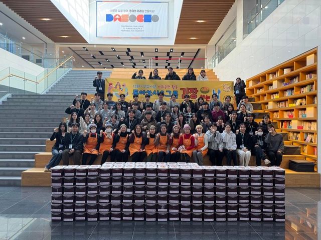 ©AP신문(AP뉴스)/이미지 제공 = 동아쏘시오그룹 ▲동아쏘시오그룹 사랑의 김장 나눔 봉사활동에 참여한 신입사원과 관계자들이 직접 담근 김치통 뒤에서 밝은 미소를 지으며 기념 촬영을 하고 있다. 이날 만든 김치들은 지역 사회 이웃에게 전달되어 따뜻한 겨울나기를 도울 예정이다.