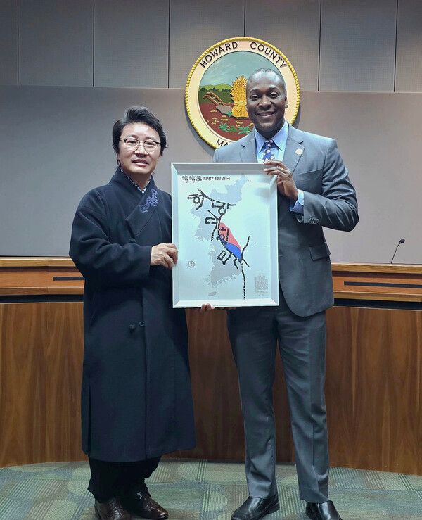 한한국 세계평화작가가 미국 메릴랜드주 하워드 카운티 정부청사에서&nbsp;캘빈 볼 시장에게 ‘희망 대한민국’ 지도를 전달하고 있다(사진=한한국 세계평화작가)