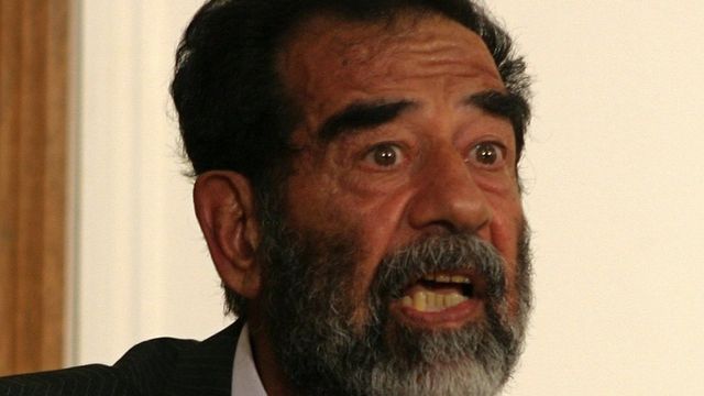 Former Iraqi President Saddam Hussein talks to an Iraqi judge during his initial interview at an undisclosed location in Baghdad on 1 July, 2004