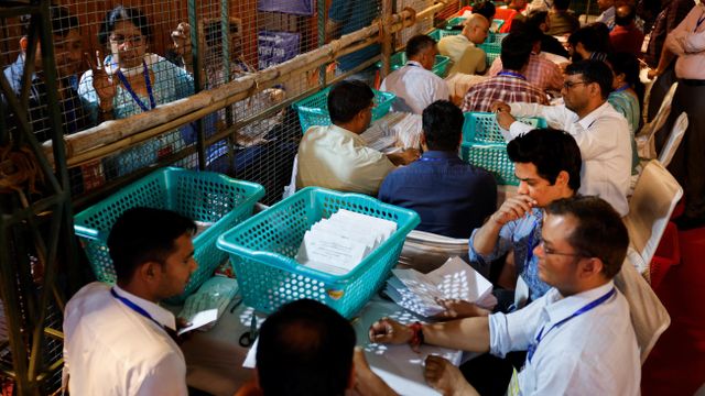 선거 관계자들이 투표 용지를 세고 있는 모습