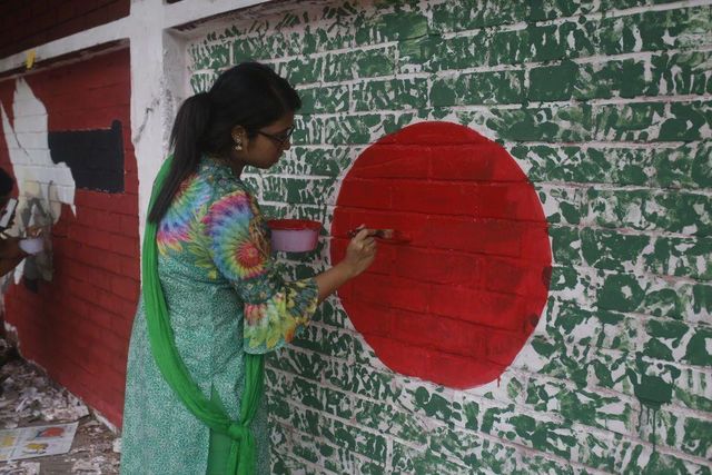 지난 12일, 손바닥으로 그린 방글라데시 국기 그림을 완성하는 여성의 모습