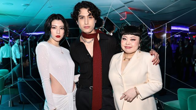 키가 크고 날씬한 남성과 여성 옆에 서 있는 나오미 와타나베