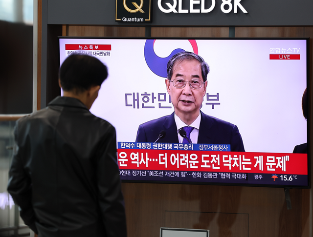 한 시민이 한덕수 대통령 권한대행 국무총리의 대국민담화를 지켜보고 있다