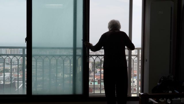 할머니가 창 밖을 바라보고 있다