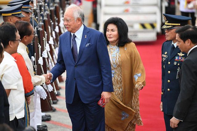 나지브 전 총리와 로스마 여사가 환영 사절단을 향해 인사를 건네고 있다