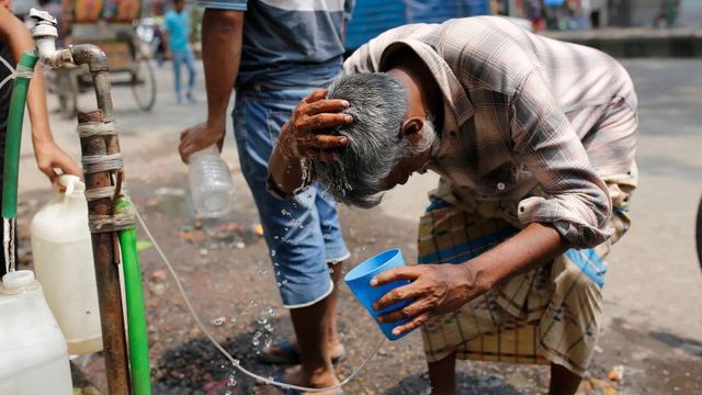 방글라데시 다카에서 머리에 물을 뿌리는 남성의 모습