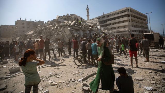 팔레스타인인들이 거대한 건물 잔해 더미 속에서 생존자를 찾는 모습