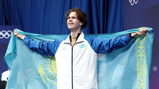 미하일 샤이도로프가 국기를 듣고 감격스러운 표정을 짓고 있다