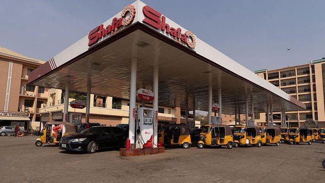 주유소에 차량과 노란색 툭툭이 줄지어 서 있는 모습