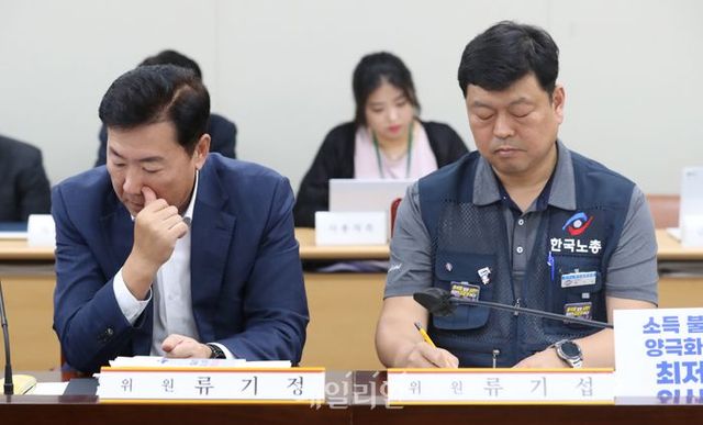 27일 세종시 정부세종청사에서 열린 최저임금위 8차 전원회의에서 류기정 사용자 위원과 류기섭 근로자 위원이 경직된 표정으로 나란히 앉아 있다. 이날 회의는 근로자 위원들이 구속 중인 김준영 한국노총 금속노련 사무처장을 근로자위원에서 직권해촉한 것에 항의하며 퇴장했다.ⓒ뉴시