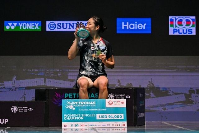 우승 트로피에 입 맞추는 안세영. ⓒ AP=뉴시스