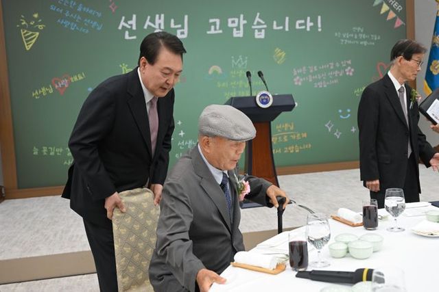 윤석열 대통령이 지난해 5월 15일 서울 용산 대통령실 청사에서 열린 제42회 스승의 날 기념 현장교원 초청 오찬 간담회에서 윤 대통령의 충암고 시절 은사인 최윤복 선생님의 착석을 도와주고 있다. ⓒ대통령실