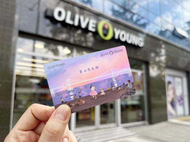 CJ올리브영이 부산시와 협업해 부산청년응원 프로젝트 '영부산'을 진행한다. 올리브영이 부산 청년 작가 '노콩'과 협업해 제작한 '부산 기프트 카드'를 들고 있다. /사진=CJ올리브영