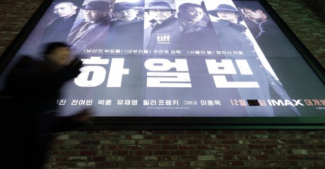24일 서울 CGV용산아이파크몰에서 영화 관람객이 '하얼빈' 홍보 스크린 앞을 지나가고 있다./사진=뉴시스 /사진=최동준
