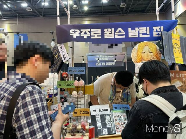 루미아 야시장에서 굿즈를 구매하는 관람객의 모습. /사진=이재현 기자