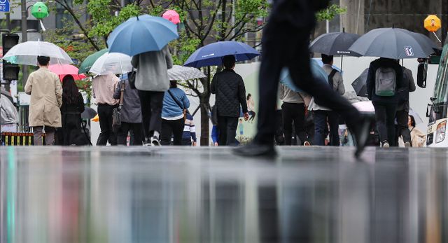 서울 종로구 광화문광장에서 우산을 쓴 시민들이 발걸음을 옮기고 있다./사진=뉴스1