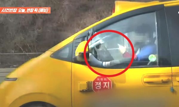 아이들을 태운 태권도 학원 차량 운전자가 충격적인 자세로 운전 중인 모습이 포착됐다. 사진은 태권도 학원 차량 운전자가 한쪽 다리를 창틀에 올리고 양손으로 휴대전화를 만지는 모습. /사진=JTBC '사건반장' 캡처