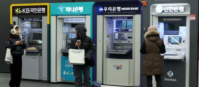 2024년 KB, 신한, 하나, 우리 등 4대 금융지주사가 사상 최대 실적을 기록하며 이자이익 총액만 41조8760억원에 이르는 것으로 집계됐다.서울의 한 건물에 설치된 은행 ATM기 앞으로 시민이 지나가고 있다. /사진=뉴시스