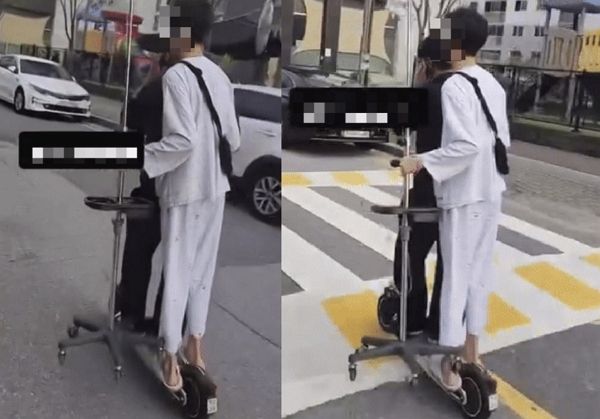 학생으로 추정되는 남성 두 명이 전동 킥보드 한 대를 함께 타고 주행하는 영상이 확산했다. 사진은 헬멧을 착용하지 않은 두 명이 전동 킥보드에 탑승한 모습. /사진=온라인커뮤니티 '보배드림' 캡처