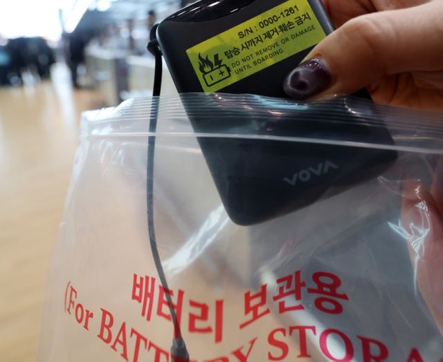 정부가 기내 보조배터리 안전대책을 이달 발표한다. 사진은 인천국제공항 제2여객터미널 대한항공 체크인 카운터에서 관계자가 보조배터리에 스티커를 부착한 뒤 비닐봉지에 담던 모습. /사진=뉴시스