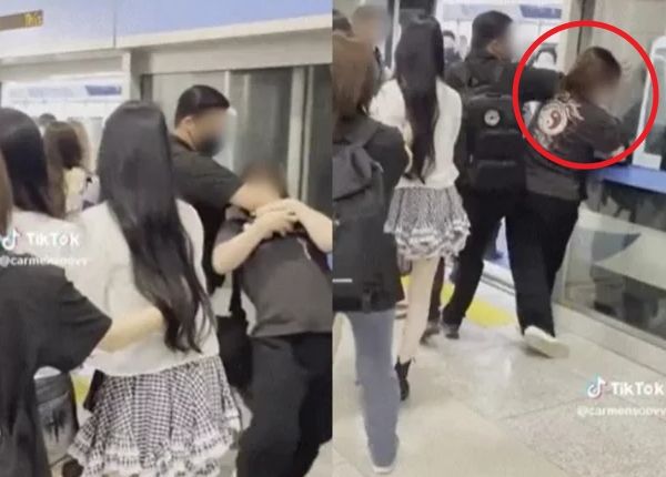 걸그룹 하츠투하츠 경호원이 과잉 경호 논란에 휩싸였다. 사진은 경호원이 한 시민을 제지하는 모습. /사진=SNS 캡처