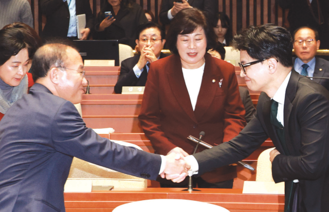 한동훈 법무부 장관과 윤재옥 국민의힘 원내대표가 6일 국회 예결위회의장에서 열린 국민의힘 정책의원총회에 참석해 악수하고 있다 사진연합뉴스