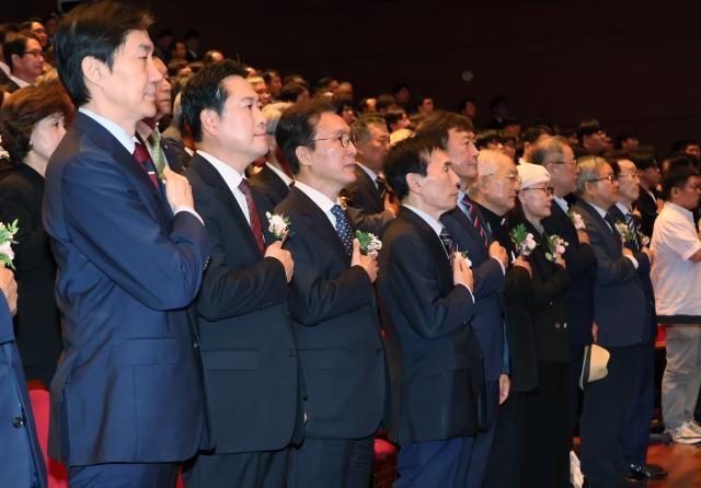 16일 경남 창원시 3·15아트센터에서 열린 제46주년 부마민주항쟁 국가기념식에서 김민석 국무총리왼쪽 세 번째와 조국혁신당 조국 비대위원장 국민의힘 장동혁 대표 등 참석자들이 국기에 경례하고 있다 사진연합뉴스