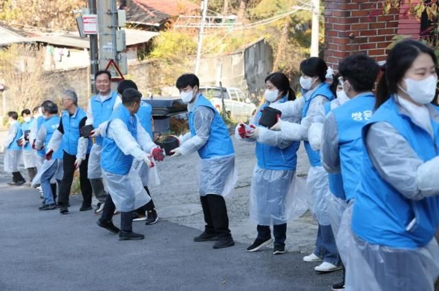 쌍용CE 본사 임직원들이 지난 12일 서울시 성북구 정릉3동 1통 일대서 열린 ‘사랑의 연탄 나눔’ 행사에서 연탄을 전달하고 있다 사진쌍용CE