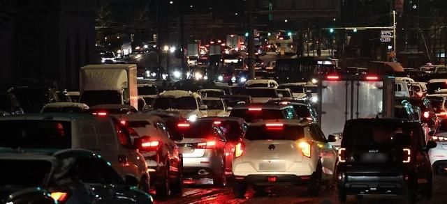 올겨울 많은 양의 첫눈이 내린 4일 서울 종로구 경복궁역 인근에서 차량이 빙판길에 정체를 빚고 있다 사진연합뉴스