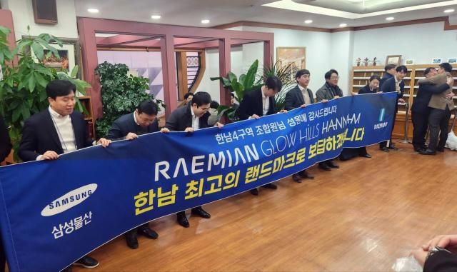 18일 서울 용산구 이태원동의 한 교회에서 진행된 한남4구역 재개발정비사업 조합원 총회 결과 삼성물산이 시공사로 선정되자 삼성물산 관계자들이 감사 인사를 하고 있다 2025118 