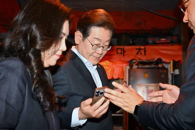 이재명 더불어민주당 대선 후보가 1일 서울 종로구의 한 포차 식당에서 당신의 하루를 만드는 보이지 않는 영웅들이란 주제로 배달 라이더 택배 기사 등 비非전형 노동자들과 간담회를 마친 뒤 휴대전화를 확인하고 있다 사진연합뉴스