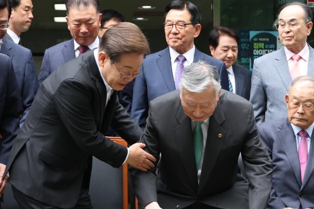 이재명 더불어민주당 대선 후보가 19일 서울 용산구 대한노인회관을 방문 기념촬영 자리에 앉는 이중근 회장을 부축하고 있다 사진연합뉴스 