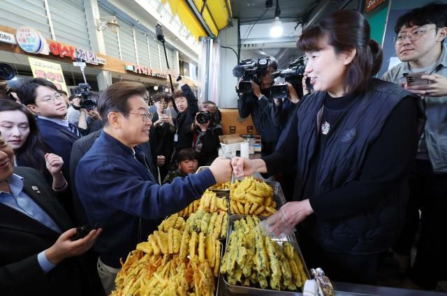 이재명 더불어민주당 대선 후보가 골목골목 경청투어 접경지역 방문 이틀째인 2일 강원 철원군 동송전통시장에서 분식점을 찾아 상인과 주먹을 맞대고 있다 사진연합뉴스