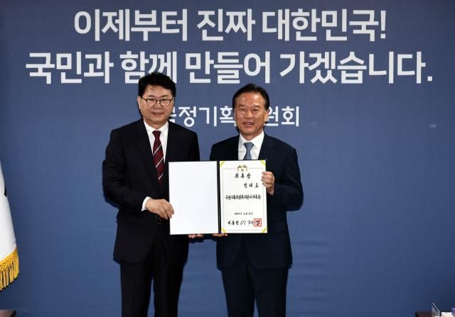 이한주 국정기획위원회 위원장왼쪽이 16일 서울 종로구 정부서울청사 창성동 별관에서 열린 출범식에서 경제1분과장을 맡은 정태호 더불어민주당 의원에게 위촉장을 수여한 뒤 기념촬영을 하고 있다 사진연합뉴스