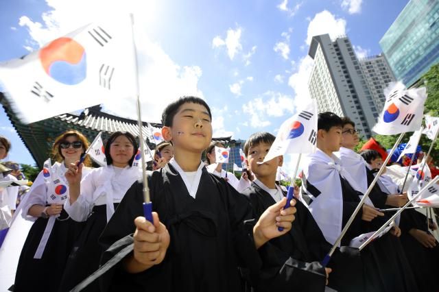 광복절을 앞둔 14일 오후 대구 중구 국채보상운동 기념공원에서 국채보상운동 기념사업회 주최로 열린 광복 80주년 기념 플래시몹 퍼포먼스에서 참가자들이 태극기를 흔들고 있다 사진연합뉴스