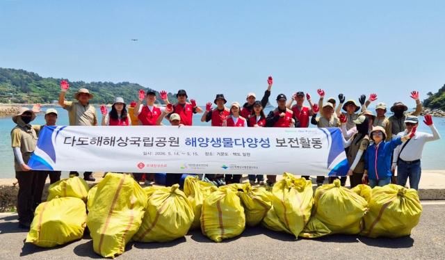 롯데칠성음료 임직원들이 1415일 거문도에서 해양생물 서식지 정화활동을 진행했다 해안 정화활동에 참여한 관계자들이 단체사진을 촬영하고 있다 사진롯데칠성음료