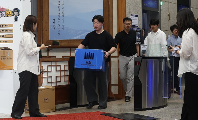 검찰과 경찰이 지난 21일 장윤기 사건 부실 수사와 증거인멸 의혹 등을 규명하기 위해 경찰청 국가수사본부를 동시에 압수수색 했다 이날 서울 서대문구 경찰청에서 검찰 관계자들이 압수물이 담긴 상자를 들고 이동하는 모습 사진연합뉴스