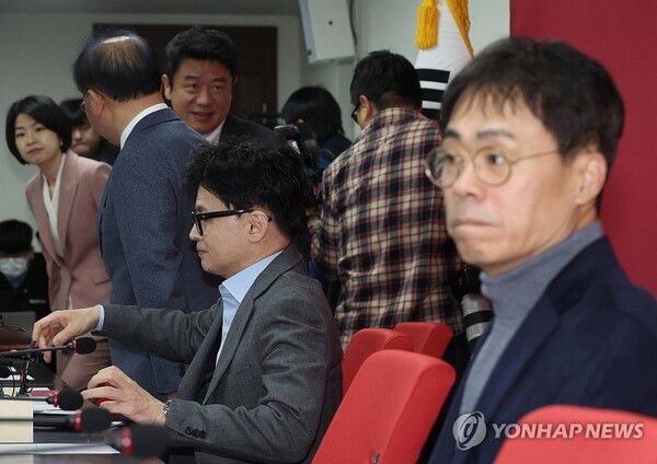 국민의힘 한동훈 비상대책위원장이 25일 여의도 당사에서 열린 비대위 회의에 입장해 착석하고 있다. 오른쪽은 김경율 비대위원. [사진=연합뉴스]