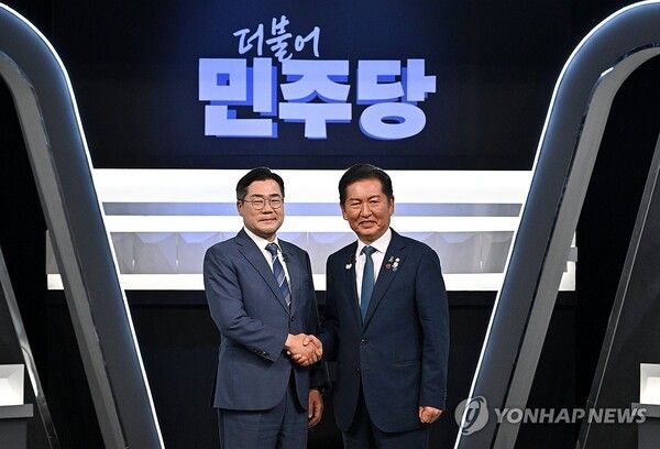 더불어민주당 박찬대, 정청래 당대표 후보가 27일 서울 여의도 KBS 신관 공개홀에서 열린 TV토론회 시작에 앞서 악수를 하며 기념촬영하고 있다. [사진=연합뉴스]