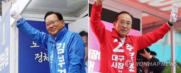 더불어민주당 김부겸 대구시장 후보(왼쪽)와 국민의힘 추경호 대구시장 후보가 21일 대구 범어네거리와 반월당사거리에서 출근길 인사를 하고 있다.[사진=연합뉴스]