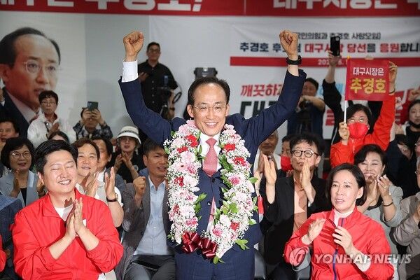국민의힘 추경호 대구시장 후보가 당선이 유력시되면서 4일 오전 대구 범어네거리 선거사무소에서 축하 꽃다발을 목에 걸고 있다.[사진=연합뉴스]