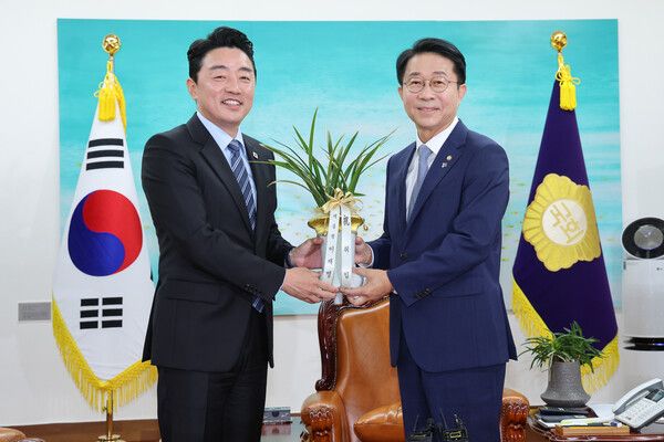 조정식&nbsp;국회의장(오른쪽)이 9일 취임 축하 인사차 예방한 강훈식 대통령 비서실장에게서 이재명 대통령이 보낸 축하 난을 받고 있다. [사진=연합뉴스]