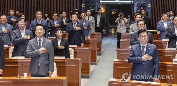 국민의힘 장동혁 대표(앞줄 왼쪽)와 정점식 원내대표(앞줄 오른쪽)를 비롯한 의원들이 23일 국회에서 열린 22대 하반기 국회 상임위원장 후보 선출을 위한 의원 총회에서 국기에 경례하고 있다.[사진=연합뉴스]